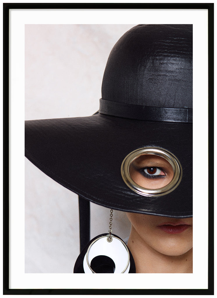 Poster of woman with big black hat. White background. Black frame. 