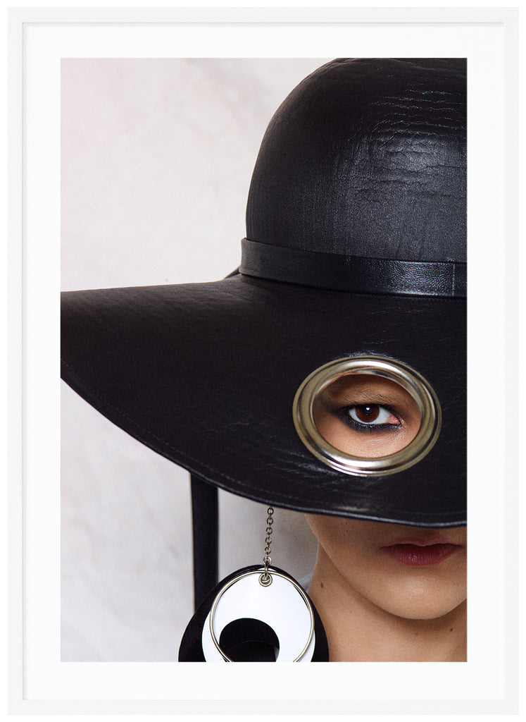 Poster of woman with big black hat. White background. White frame. 