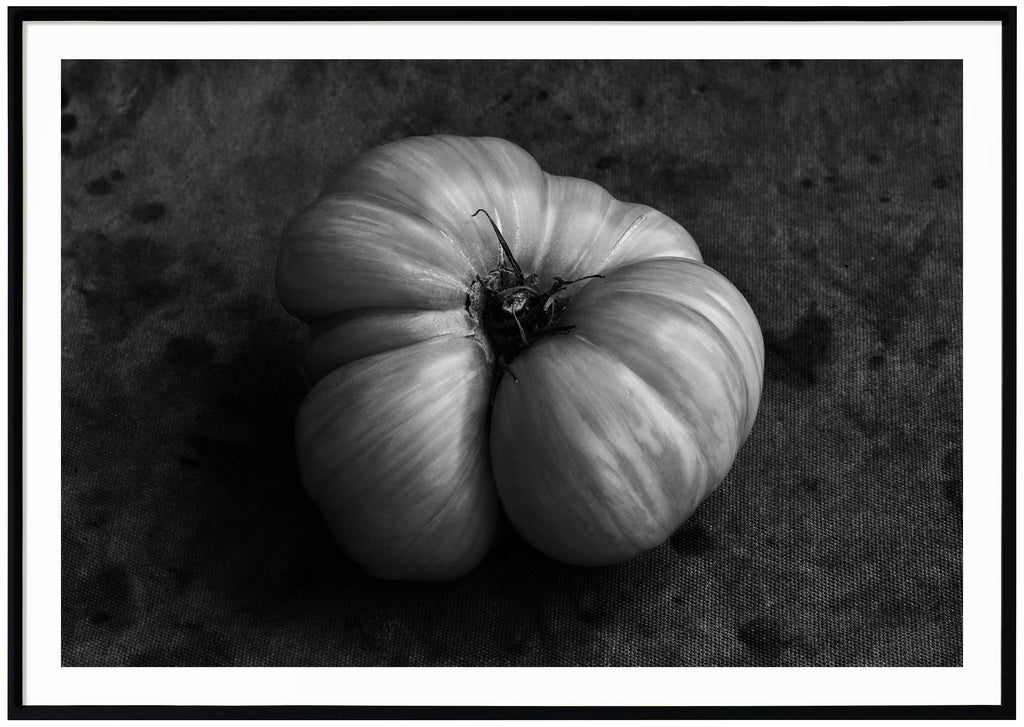 Black and white still life of a tomato. Black frame.