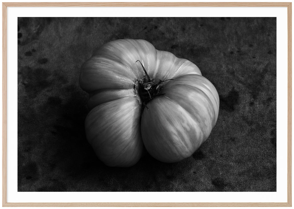 Black and white still life of a tomato. Oak frame.