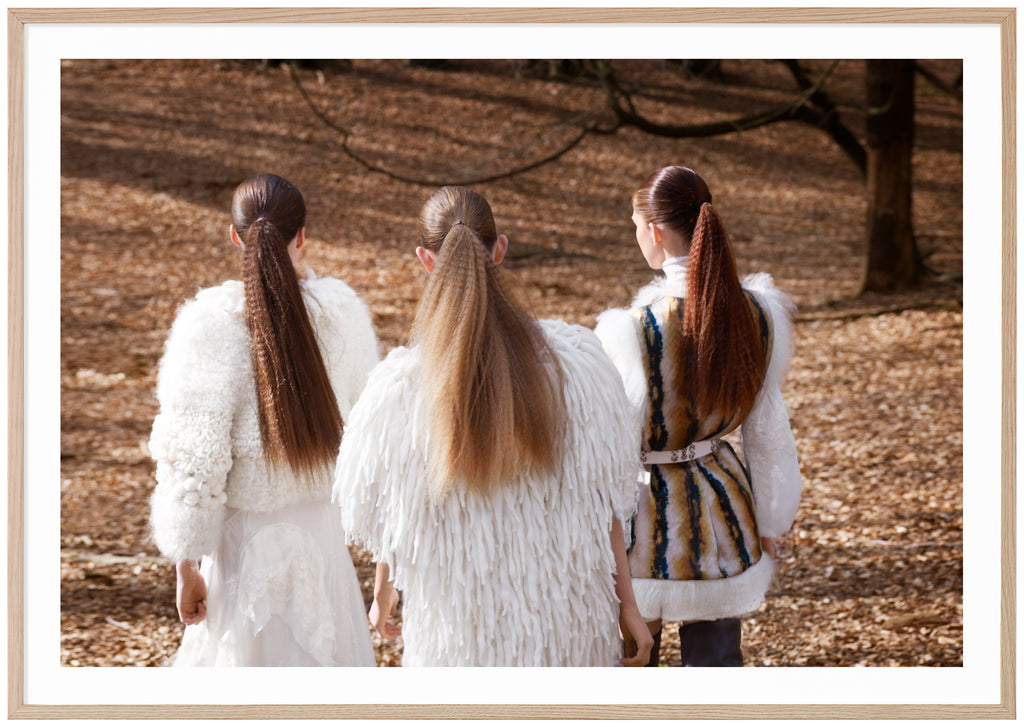 Fashion photograph of three women in long ponytails. Oak frame. 