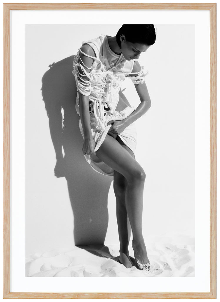 Black and white photograph a posing woman in white stringy clothes. Oak frame. 