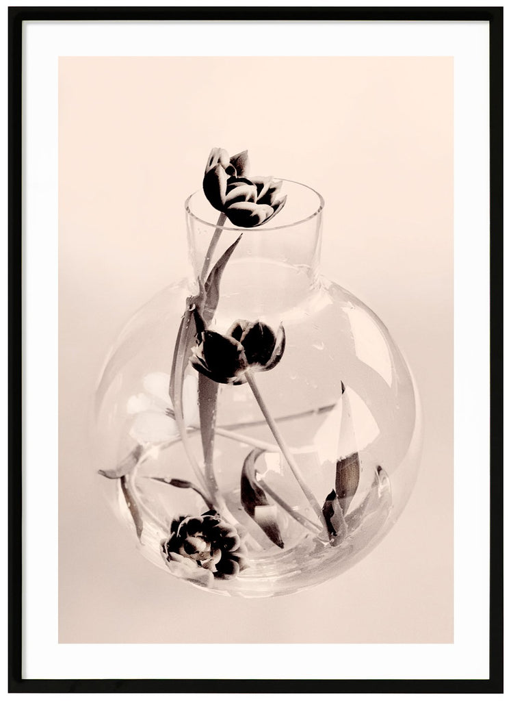 Graphic photo art of a glass vase with a number of tulips that have collapsed in it.  Black frame.
