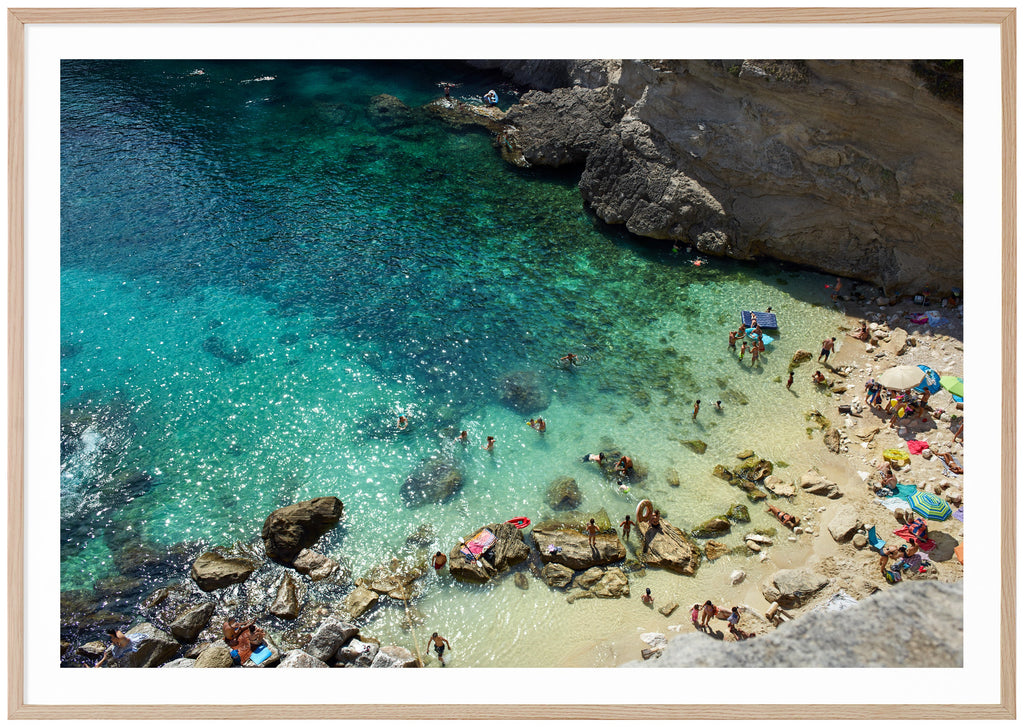 Color photography of a beach and cliffs in southern Italy. Oak frame. 