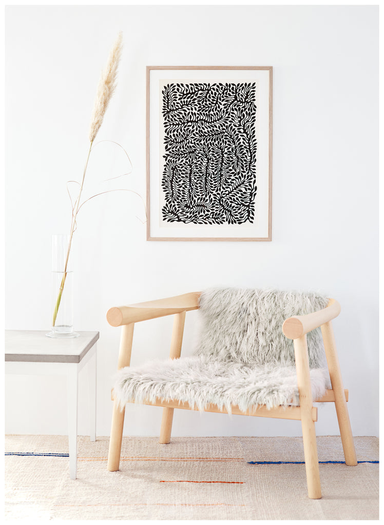 Black and white poster of leaf-like pattern, by the Swedish artist Henrik Delehag.  White frame.