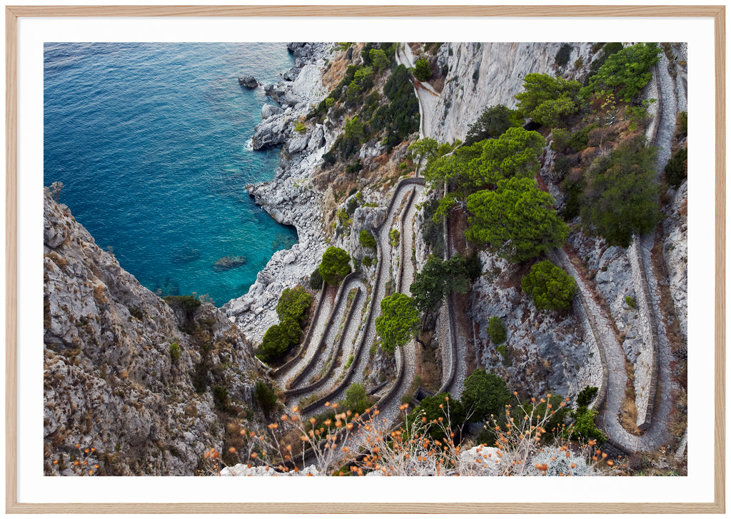Color photography of a view of a stone promenade on the Italian island of Capri. Oak frame.