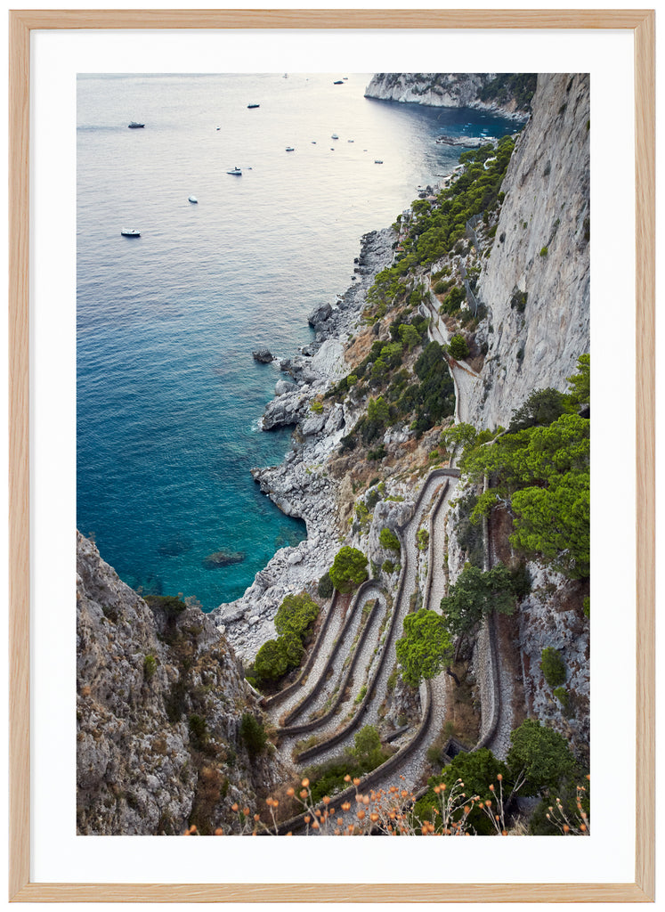 Color photography of a view of a stone promenade and boats on the Italian island of Capri. Oak frame. 