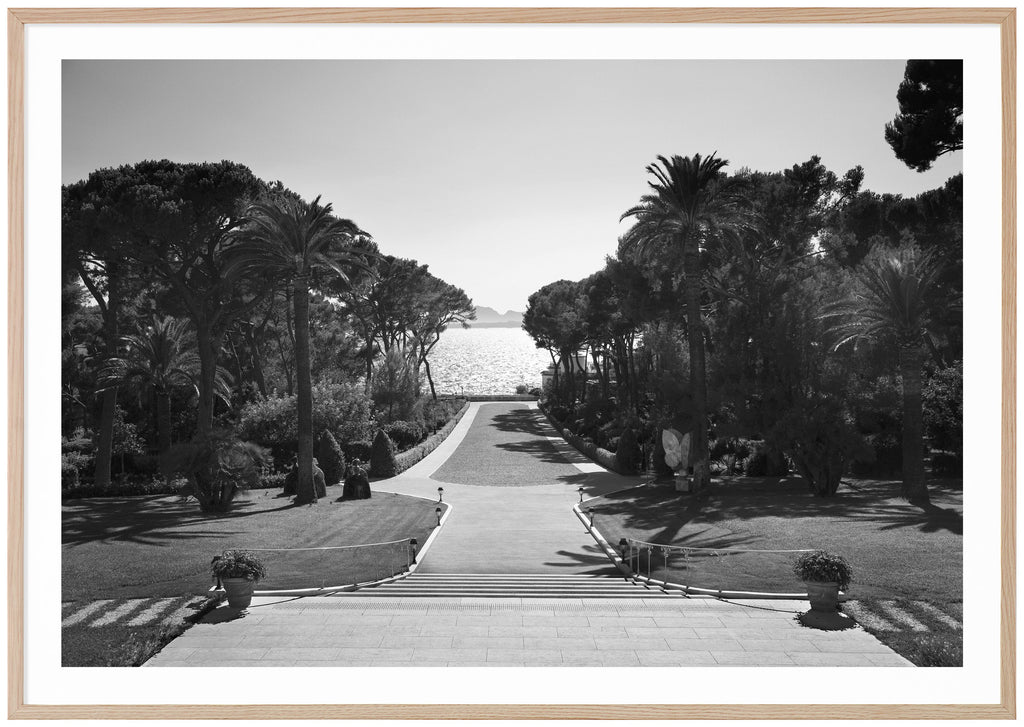Black and white photography with a view of an incredible backyard with the water glistening with the sun. Oak frame. 