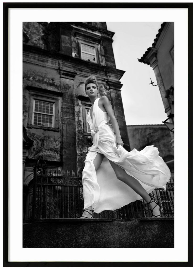 Black and white fashion photography of a woman in white dress. Black frame. 