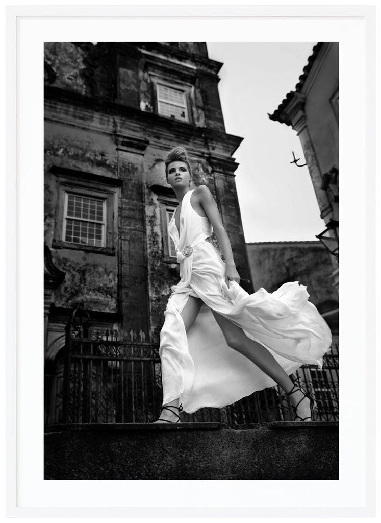 Black and white fashion photography of a woman in white dress. White frame.